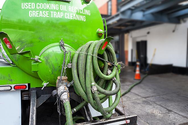 a technician pumping a grease trap in a commercial building in Castaic, CA